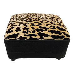 a leopard print foot stool with black legs