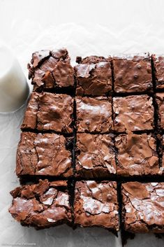 chocolate brownies cut into squares next to a glass of milk