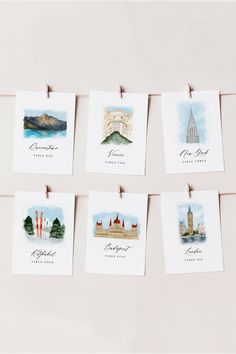 there are many cards hanging on the clothesline with pictures of different countries in them