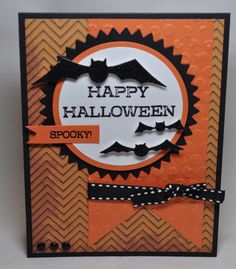 an orange and black halloween card with bats