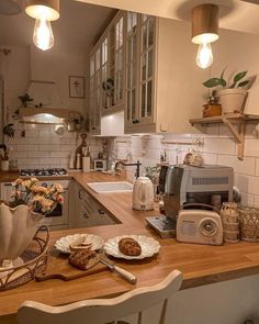 a kitchen filled with lots of counter top space and wooden counters topped with plates full of food