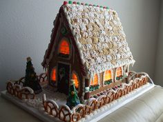 a gingerbread house is lit up for christmas