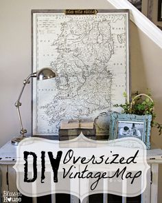 an old map is displayed on top of a small table in front of a stair case