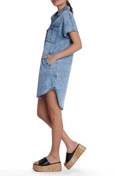 This season-staple denim dress is designed with abbreviated sleeves and a curved high-low hem. Front button closure Spread collar Short sleeves Chest button-flap patch pockets; side pockets 62% lyocell, 20% cotton, 12% polyester, 5% rayon, 1% spandex Machine wash, tumble dry Imported Summer Denim Washed Shirt Dress, Medium Wash Knee-length Shirt Dress With Pockets, Knee-length Medium Wash Shirt Dress With Pockets, Casual High-low Hem Shirt Dress For Spring, Casual Knee-length Denim Dress, Casual Knee-length Denim Dress For Daywear, Short Sleeve Denim Shirt Dress For Daywear, Knee-length Denim Shirt Dress For Daywear, Spring Casual Shirt Dress With Curved Hem