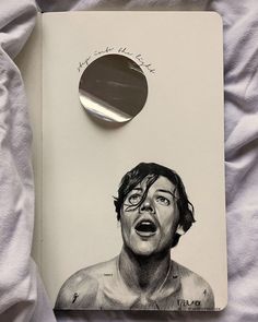 a drawing of a shirtless man with his mouth open next to a round mirror