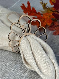 a napkin holder with a metal flower on it