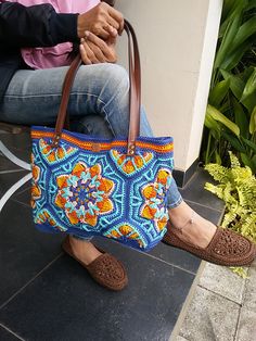 a woman sitting on a bench holding a purse