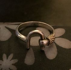 "Hello and Welcome to LiamBySevanna! Prior-purchasing any listing from this shop, please Ask question/s, Request additional photos, to make sure the listed item, is the right choice for you! Per our store policy we don't accept returns Listing is for: Vintage 925 Sterling Silver & 14k Gold Horse Shoe Ring Size 6.75 and weights 2.6 Grams. Marked 925 & 14k on the inside. Only the wrapped rope is gold and the rest is sterling silver. Its well made ring, well may need cleaning and buffing prior wear, which would be left to you decide. (Other tings on models hand does not include the listing) Reminder: You can \"always\" prevent any wrong purchase/s by Communicating, Inquiring and Questioning Prior making any Purchase! We provide pictures and share any info known about the listing accordingly. Equestrian Ring, Rope Wrapped, Gold Horse, Band Rings, Ring Size, Jewelry Rings, 925 Sterling Silver, Band, Sterling Silver