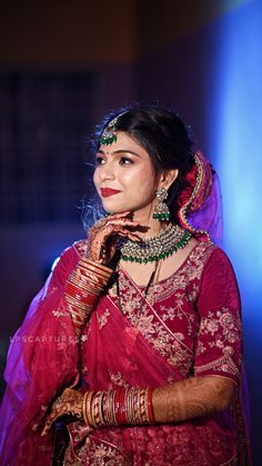 a woman in a red sari and jewelry