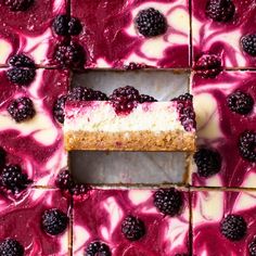 a slice of cheesecake with raspberry sauce and blackberries on the top