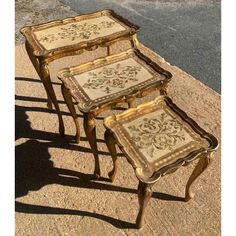 three tables sitting on top of a sidewalk