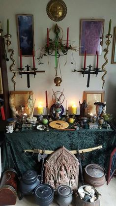 a table topped with lots of candles next to pictures