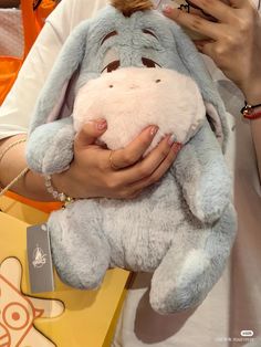 a person holding a stuffed animal in their hands