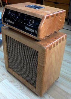 an old radio sitting on top of a wooden table