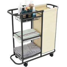 a black rolling cart with two shelves and towels on it's wheels, holding various items