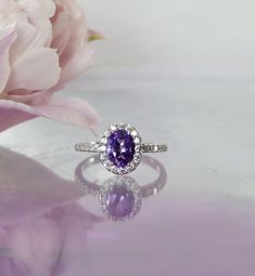 Purple amethyst halo sterling ring is stunning.  Natural purple amethyst measures 8 x 6 is 100 percent natural and has not been in enhanced in anyway.  Amethyst is eye clean and has sparkling clarity. This gem weighs 1.10 carats with a stunning lilac color. Set in a beautifully crafted sterling silver halo design.  Bonded with rhodium to help prevent tarnish. This ring is currently a size 8 however we will customize to fit your requirements free of charge. Please allow two weeks for custom sizin Amathus Ring, Elegant Amethyst Crystal Ring Round Cut, Silver Amethyst Birthstone Ring, Round Cut, Purple Spiritual Crystal Ring, Oval, Rings Purple, Purple Amethyst Crystal Ring, Oval Shaped, Amethyst Rings, Purple Ring, Silver Bands