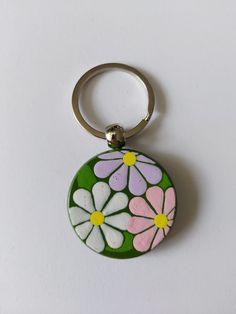 a key chain with flowers painted on it