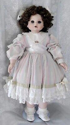 a doll that is wearing a white dress and laces on it's head