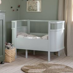 The new luxury Sebra cot bed in mist green is designed to grow with your child and can be used from birth all the way up to 8 years old. The bed is equipped with a height-adjustable base and removable side panels that transform the cot into a junior bed. The adjustable mattress is also available to add to your order, this comes in two parts, one which fits the cot and an additional panel as your child grows. Available in the classic style or the harmony which is a high-quality specialty version Sebra Bed, Kids Room Aesthetic, Baby Cot Bedding, Entrance Furniture, Junior Bed, Baby Zimmer, Shoe Storage Shelf, Daybed Covers, Bed Shelves