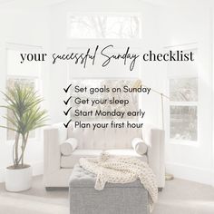 a white couch sitting in a living room next to a potted plant and window