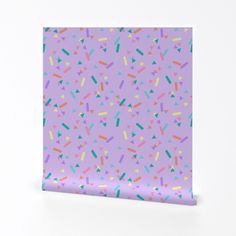 a purple wrapping paper with sprinkles on it