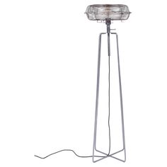 a metal floor lamp with a glass shade