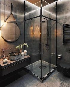 a bathroom with a glass shower stall, sink and mirror on the wall next to it