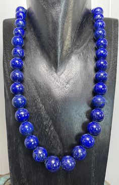 Lovely Lapis Lazuli Necklace! Elegant fall to this stunning Lapis Lazuli necklace! Choose from multiple lengths and size beads! Lovely dark blue gem quality Lapis! Because of its connection to cosmic/heaven energies, lapis lazuli is also believed to provide protection and shield the wearer from negative influences. The water element color of the stone helps purify lower energies from one's body and align it with higher, healthier vibrations. Works well with the throat chakra for vocalists, teach Luxury Lapis Lazuli Elegant Necklace, Luxury Traditional Lapis Lazuli Necklaces, Cheap Artisan Blue Necklaces, Luxury Lapis Lazuli Women's Necklaces, Luxury Sapphire Necklaces With Gemstone Beads, Luxury Blue Beaded Necklace With Large Beads, Luxury Traditional Lapis Lazuli Jewelry, Luxury Blue Beaded Necklace For Statement, Luxury Lapis Lazuli Faceted Beads Necklace