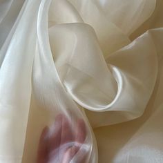 Ivory Crystal Organza Fabric by the yard, bulk or wholesale.  Delicately sheer, lightweight, and incredibly soft to the touch, it's the ideal choice for a wide range of projects. Our Ivory Organza fabric is perfect for creating exquisite garments and decorations.  Crafted from 100% polyester, this lightweight fabric offers a sheer and crisp drape, providing strength and elegance in every project. Whether you're designing ball gowns, wedding dresses, blouses, scarves, bridal apparel or fabric roses, organza is the ideal choice for achieving voluminous and structural effects. This pearl organza fabric is also perfect for event decorations. Whether it's baby shower decor or wedding decorations, the sheer beauty of this organza fabric adds a captivating touch to any setting.  Product Details: Elegant Cream Sheer Tulle Fabric, Bridal Apparel, Fabric For Dresses, Fashion Crafts, Event Decorations, Fabric Roses, Fabric Suppliers, Organza Fabric, Crafty Projects