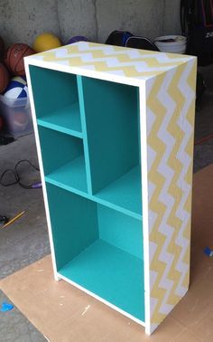 a bookcase made out of cardboard and painted blue