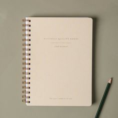 a notebook with a pencil next to it