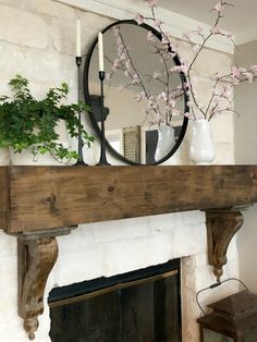 a fireplace with a mirror and flowers on it