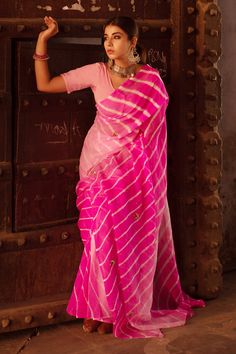 Pink saree in chiffon base with leheriya work, embroidered with gota motifs and silk threads. Comes with blouse.
Component: 2
Pattern: Embroidered
Type Of Work: Gota Motifs
Fabric: Pure Chiffon
Color: Pink
Other Details: 
Shades of pink leheriya work
Gota and silk thread work
Occasion: Wedding - Aza Fashions Pink Leheriya Saree, Leheriya Saree, Urban Chic Outfits, Best Indian Wedding Dresses, Kalamkari Blouse, Pure Chiffon Sarees, Antique Necklaces, Sari Blouse Designs, Traditional Indian Outfits