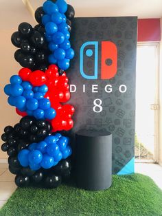 balloons are stacked on top of each other in front of a sign that reads diego 8