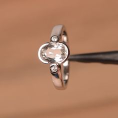 It is a natural white topaz ring. The main stone is 6 mm*8 mm oval cut.weight about 1.47 carats.The basic metal is sterling silver and plated with rhodium.To change the metal to a solid gold (white/rose) or platinum is also available, please ask for a quotation if you want.You can also go to my shop Home for more elegant rings: https://www.etsy.com/shop/godjewelry?ref=hdr_shop_menu White topaz is the November birthstone .More white topaz rings:https://www.etsy.com/shop/godjewelry?search_query=wh Oval Topaz Ring With Rose Cut Diamonds For Promise, Oval Topaz Promise Ring With Rose Cut Diamonds, 14k White Gold Oval Topaz Ring, White Gold Oval Topaz Ring For Anniversary, Oval White Gold Topaz Ring For Anniversary, Oval White Gold Topaz Anniversary Ring, Diamond White Oval Topaz Ring For Anniversary, Oval White Topaz Diamond Ring For Anniversary, Oval White Topaz Ring With Center Stone