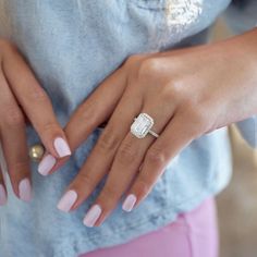 a woman's hands with pink manicures and a ring on her finger