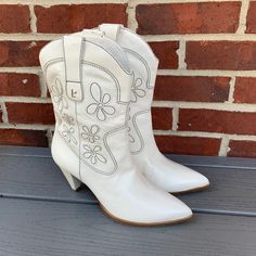 Pretty Floral Western Boots Made In Brazil From Larroude!! Features A 2 3/4" Cone Shaped Heel, 7" Shaft, Leather Upper, Lining And Sole, Pull-On Style, Floral Appliqud Design, Black Stitching, Memory Foam Cushioning And Larroude Signature Metal Logo. New, Never Worn Condition, With Minor Marks/Dirt/Creases Throughout Boots Including A Small Mark In The Leather Of The Right Boot Heel, Inner Side, And No Wear/Dirt To Soles, As Pictured. Size 8. Ivory Floral. Firm Price!! White Heeled Boots With Round Toe For Spring, Spring Stacked Heel Snip Toe Heels, White Fitted Heels With Reinforced Heel, White Boots With 4-inch Heel And Round Toe, White High Heel Boots For Spring, Fitted White Heeled Boots With Almond Toe, White Fitted High Heel Boots, Fitted White High Heel Boots, Fitted White High Heeled Boots