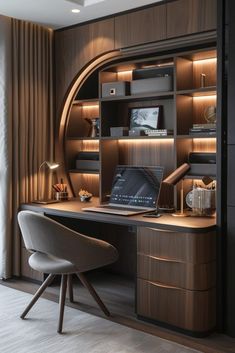 a laptop computer sitting on top of a wooden desk next to a book shelf filled with books