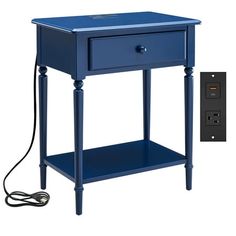 a blue table with an outlet plugged in to it and a charger on the side