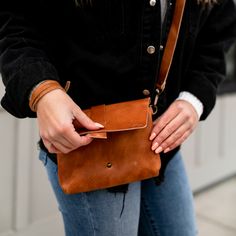 This minimal, full grain leather cross body bag is perfect for the essentials. Outfitted with a fully adjustable cross body strap, this bag will easily accommodate a minimalist wallet, phone, sunglasses and a few other small items. Take what you need without the bother of a big bag on your next outing. The strap is also removable to convert the purse into a small clutch.