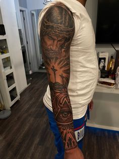 Shoulder To Elbow Tattoo Sleeve Men, Black Men Arm Tattoos Sleeve, Green Tattoo On Dark Skin, Eye Forearm Tattoo, Half Sleeve Tattoos For Guys Upper Arm, Black Jesus Tattoo, Inside Forearm Tattoo Men Sleeve, Black Men Tattoos Ideas Arm