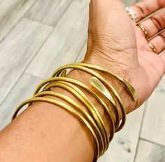 These brass bangles are a stunning addition to any jewelry collection. Handcrafted with care, this set of adjustable bracelets is perfect for anyone who loves to mix and match their accessories. Each bangle has a beautiful gold finish that adds a touch of elegance and sophistication to any outfit. These bangles are not only stylish, but also incredibly versatile. They can be worn alone as a statement piece or stacked together for a more boho-inspired look. The adjustable design makes them easy to wear and comfortable for all-day wear. This set is perfect for those who want to add a touch of elegance to their everyday wardrobe. Whether you're dressing up for a special occasion or simply adding some flair to your work-from-home outfit, these brass bangles are sure to elevate your style. Plus Stackable Brass Bangle For Gift, Stackable Brass Bangle As Gift, Adjustable Stackable Brass Bracelets, Stackable Brass Bangle Gift, Stackable Brass Bangle Bracelets, Adjustable Flexible Bangle For Gifts, Adjustable Flexible Bangle Bracelet, Copper Choker, Elephant Bangle