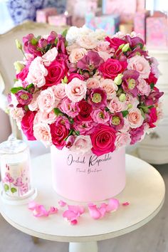 pink and white flowers in a vase on a table