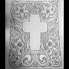 an intricate paper cutting pattern with a cross in the center and flowers around it, on a black background