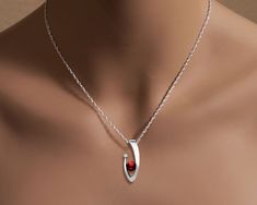 "Mozambique Garnet and White Sapphire Necklace - Argentium Silver - 3418 - Chain Included Make a statement with this contemporary design handcrafted by award winning designer, David Worcester. ( IMPORTANT - PLEASE READ 1. AND 2 BELOW ) 1.) INCLUDED IN THE PRICE IS AN ARGENTIUM SILVER CHAIN APPROPRIATE FOR THE PENDANT CHOSEN. YOU CAN CHOOSE FROM 16\", 18\" OR 20\" AT CHECKOUT. 2.) PLEASE LOOK AT THE MEASUREMENTS CAREFULLY. SOME PHOTOS HAVE BEEN ENLARGED TO SHOW DETAIL, WHILE OTHERS HAVE BEEN MINI Fine Jewelry Pendant Necklace With Tension Setting, Modern Red Ruby Jewelry, Garnet Birthstone Necklace In Fine Jewelry Style, Garnet Birthstone Fine Jewelry Necklace, Garnet Birthstone Necklaces In Fine Jewelry Style, Modern Garnet Jewelry For Anniversary, Modern Ruby Jewelry As A Gift, Elegant Red Birthstone Necklace For Anniversary, Modern Ruby Jewelry For Anniversary