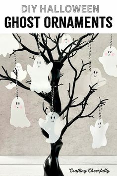 a halloween tree with ghost ornaments hanging from it