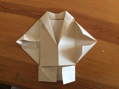 an origami shirt on a wooden table