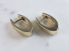 "A  LOVELY PAIR OF WOMENS 14K YELLOW GOLD HOOP EARRINGS .  THE EARRINGS WEIGH 6.7g, AND MEASURE 5/8\" LONG BY 1/2\" WIDE.  EARRINGS ARE HAVE A MAKERS MARK AND A FOREIGN 14K MARK.   NOT SURE HWO THE MAKER IS THOUGH.  MARK IS HARD TO MAKE OUT.  ANY QUESTIONS, PLEASE DON'T HESITATE TO ASK.  BE SURE TO CHECK OUT SOME OF MY OTHER OTHER GREAT ITEMS UP FOR SALE.  THANK YOU." Hallmarked Oval 14k Gold Huggie Earrings, Luxury Oval Huggie Earrings For Formal Occasions, Formal Yellow Gold Huggie Hoop Earrings, Hallmarked Huggie Earrings For Formal Occasions, Formal Hallmarked Huggie Earrings, 14k Gold Oval Huggie Earrings Hallmarked, Yellow Gold Pierced Huggie Earrings For Formal Occasions, Formal Yellow Gold Pierced Huggie Earrings, Luxury Hallmarked Huggie Earrings