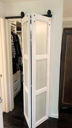 an open closet door in the middle of a room