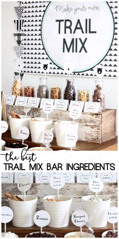 the trail mix bar ingredients are displayed in white bowls and wooden crates with labels on them